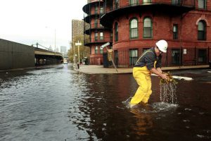 NEW YORK, NY - OCTOBER 30: A man clears leaves from a sewer drain in lower Manhattan, October 30, 2012 in New York. The storm has claimed at least 33 lives in the United States, and has caused massive flooding across much of the Atlantic seaboard. US President Barack Obama has declared the situation a 'major disaster' for large areas of the US East Coast including New York City. (Photo by Allison Joyce/Getty Images)